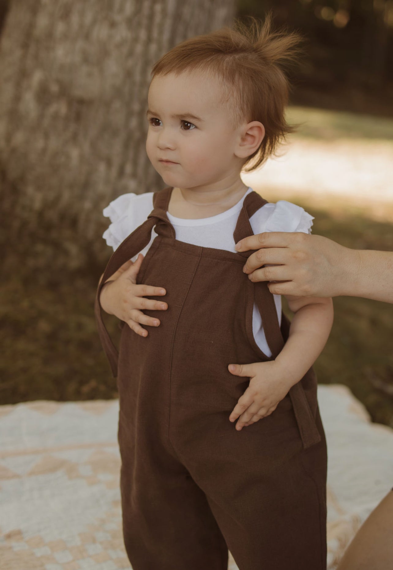 18 month old baby in Brown linen overalls