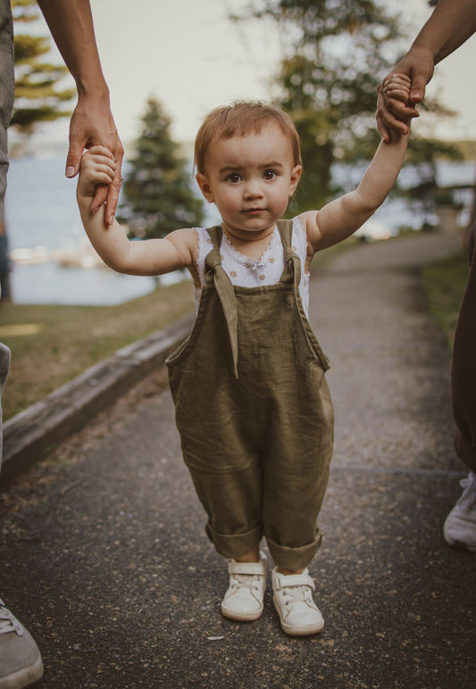 18 month old in sage green linen overalls 
